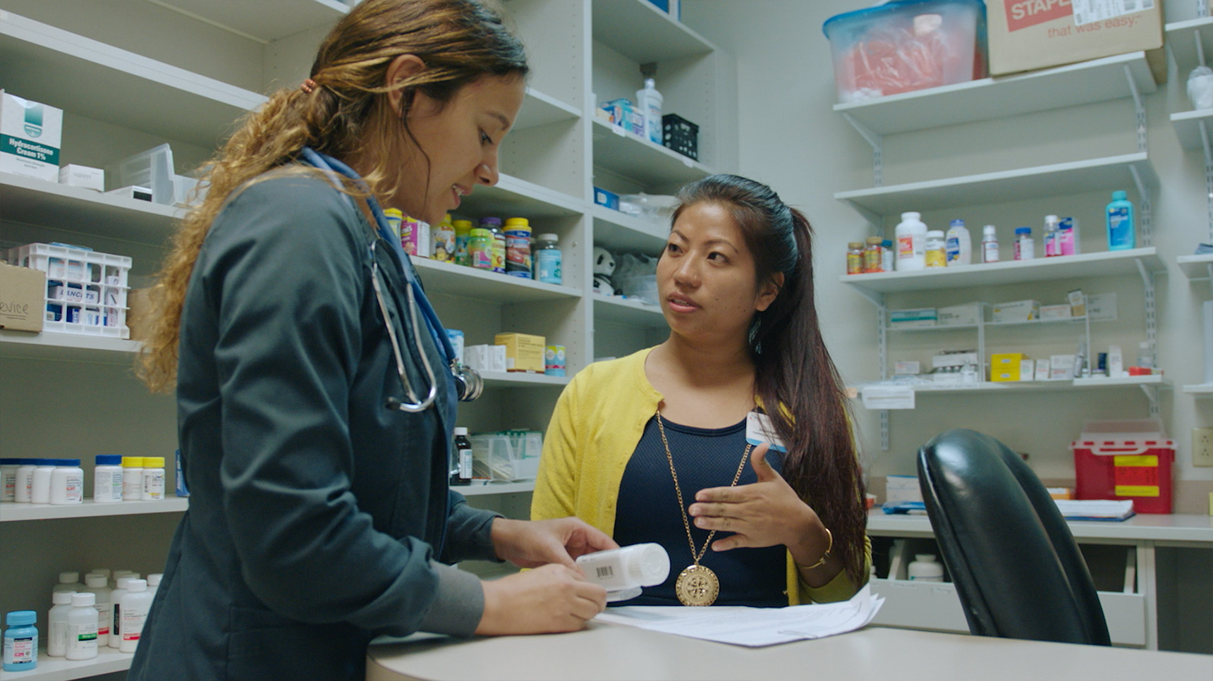siloam community health worker talks with pharmacist