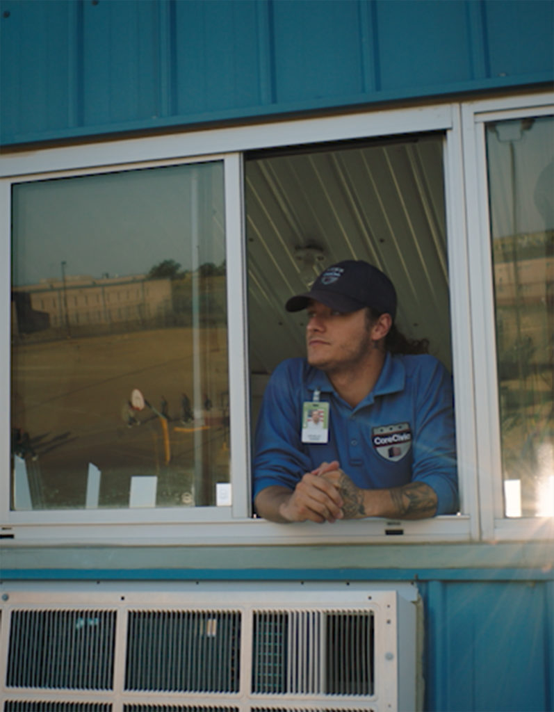 prison guard looks out from guard tower