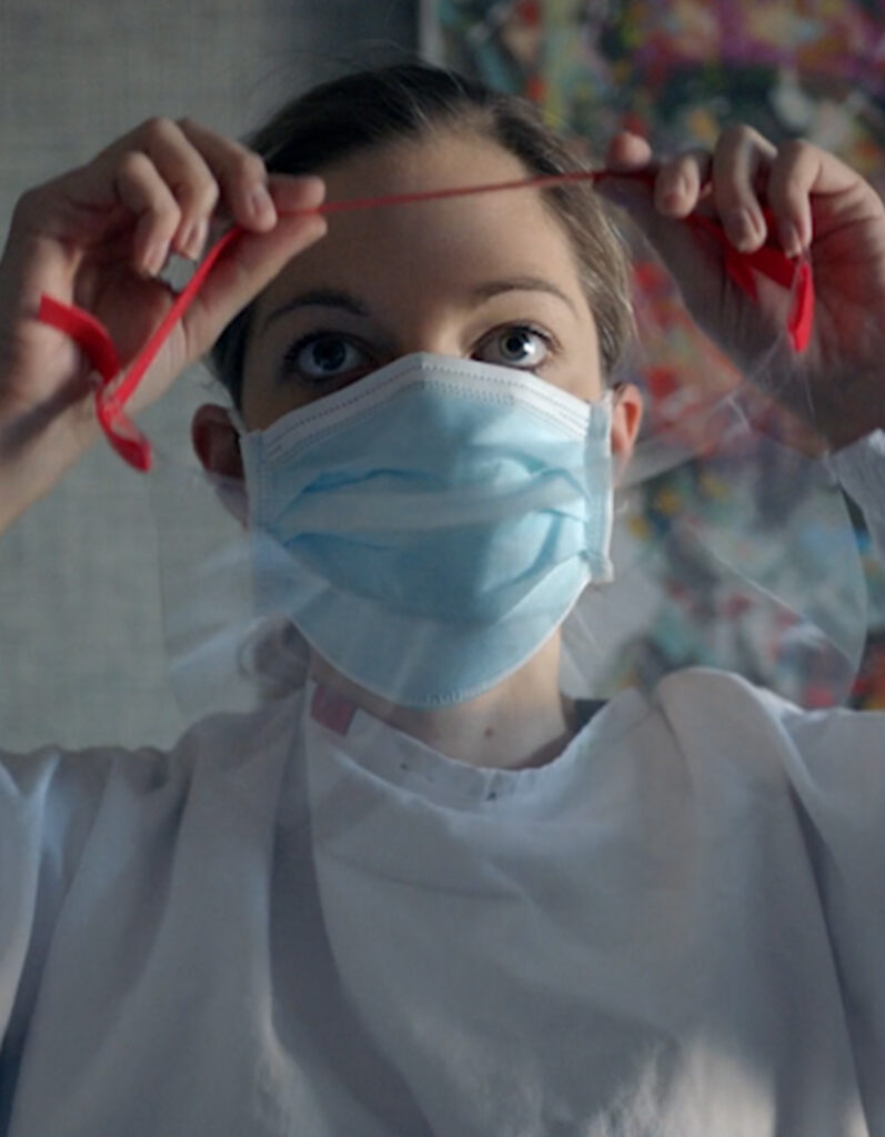 siloam nurse puts on her mask before administering covid-19 test